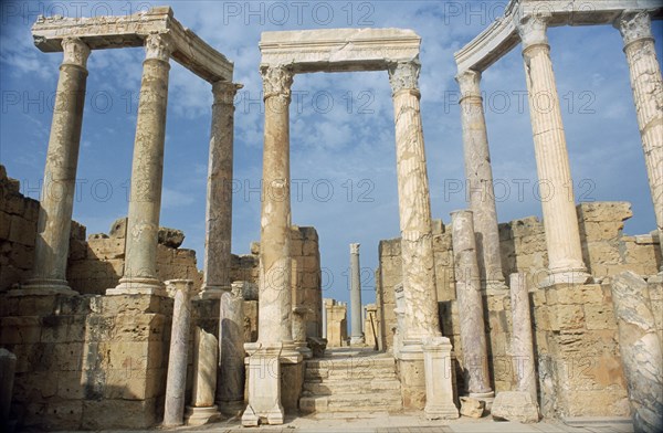 LIBYA, Tripolitania, Leptis Magna, Ruins of Roman city founded in 6th Century BC.The theatre seating and back scene.