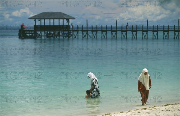 MALAYSIA, Sabah, Pulau Manukan, Muslim women bathing fully clothed.