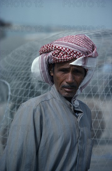 KUWAIT, People, Portrait of man wearing traditional red and white arab headscarf