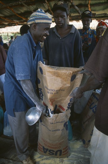 TANZANIA, West, Great Lakes Region, Mkugwa Refugee Camp.  Distribution of food aid supplying cornmeal from the United States of America.