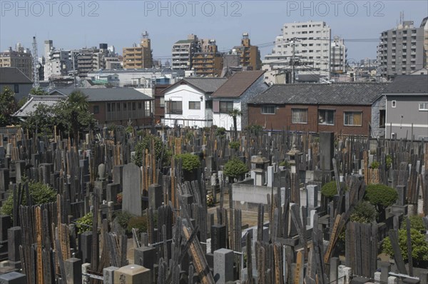 JAPAN, Honshu, Tokyo, Yanaka. View over the cemetary of Shoyomei-ji Temple closely surrounded by buildings