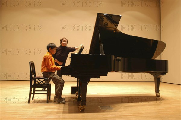 JAPAN, Chiba, Tako, 11 year old boy named Satoshi Ui plays at a piano recital