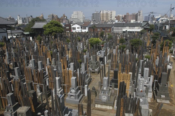 JAPAN, Honshu, Tokyo, Yanaka. View over the cemetary of Shoyomei-ji Temple closely surrounded by buildings