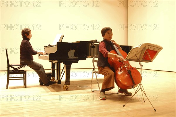 JAPAN, Chiba, Tako, 53 year old public health nurse named Teruko Ui plays cello at recital as a hobby and for relaxation