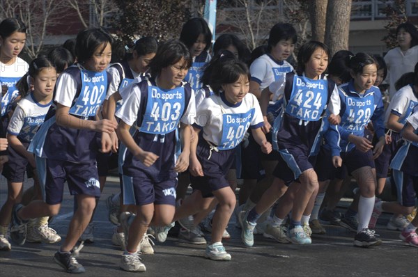 JAPAN, Chiba, Tako, 11-12 year old girls starting a 2 kilometer race which is part of the towns fitness festival