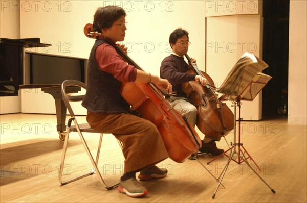 JAPAN, Chiba, Tako, "53 year old public health nurse named Teruko Ui plays cello with teacher Satoshi Miyano, at recital as a hobby and for relaxation"