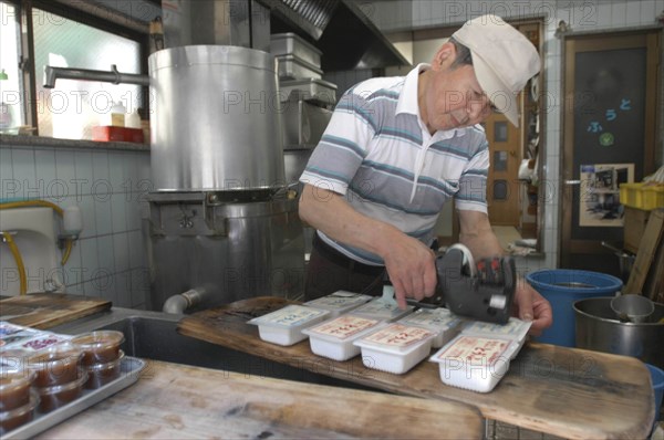 JAPAN, Honshu, Tokyo, "Yanak. Mr. Kyuhei Fukushima, 68 years old, at work in his tofu shop"