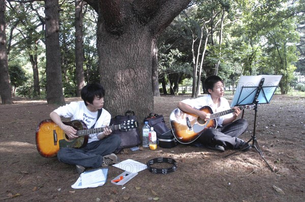 JAPAN, Honshu, Tokyo, "Yoyogi Park. Yuki Nakagawa and Yousuke Koyama, both 15 years old, meet here on Saturday afternoons to practice guitars and sing Harajuku"
