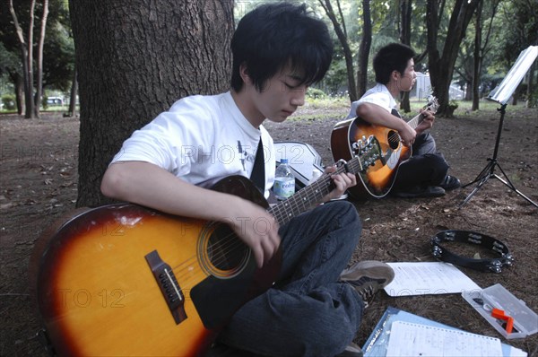 JAPAN, Honshu, Tokyo, "Yoyogi Park. Yuki Nakagawa and Yousuke Koyama, both 15 years old, meet here on Saturday afternoons to practice guitars and sing Harajuku"