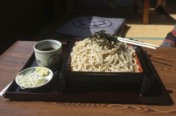 JAPAN, Chiba, Tako, """zaru soba"" cold buckwheat noodles with chilled ""tsuyu"" ( soy sauce-based dipping soup) and small plate contains chopped ""negi"" (Japanese leek) and wasabe"