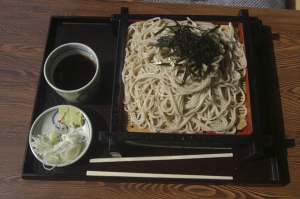 JAPAN, Chiba, Tako, """zaru soba"" cold buckwheat  noodles with ""tsuyu"" soy sauce-based dipping soup, small plate contains chopped ""negi"" (Japanese leeks) and wasabe paste"