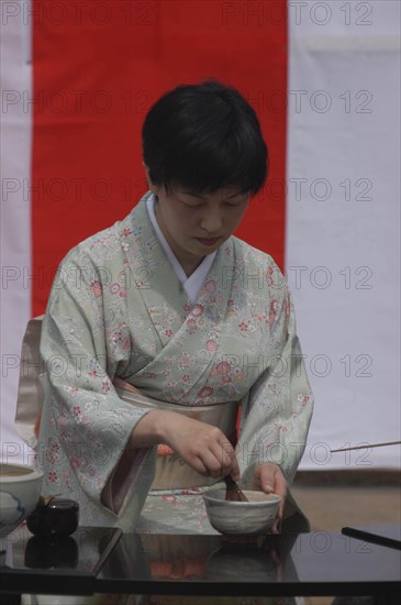 JAPAN, Chiba, Yokaichiba, "Licensed tea master Chiharu Koshikawa prepares green tea ""macha"" at a tea ceremony, wearing kimono MR"