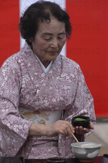 JAPAN, Chiba, Yokaichiba, "Licensed tea master Shikako Namba prepares green tea ""macha"" at a tea ceremony"
