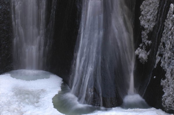 JAPAN, Ibaragi, Fukuroda-no-taki, Fukuroda Waterfalls in the winter with the gushing water at the base of the falls partially frozen into ice