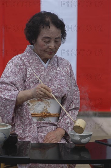 JAPAN, Chiba, Yokaichiba, "Licensed tea master Shikako Namba prepares green tea ""macha"" at a tea ceremony, senior citizen, wearing kimono"