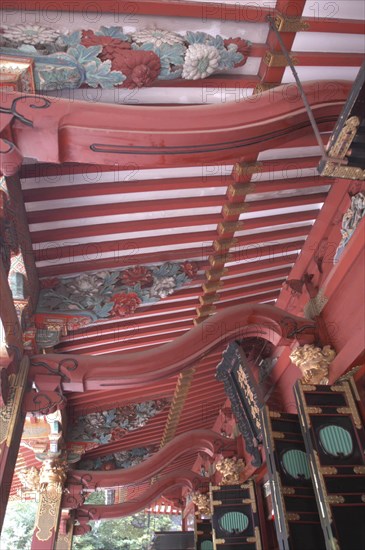 JAPAN, Honshu, Tokyo, Nezu Jinja. Momoyama style elaborate decoration of the shrine's veranda in a vermillion color