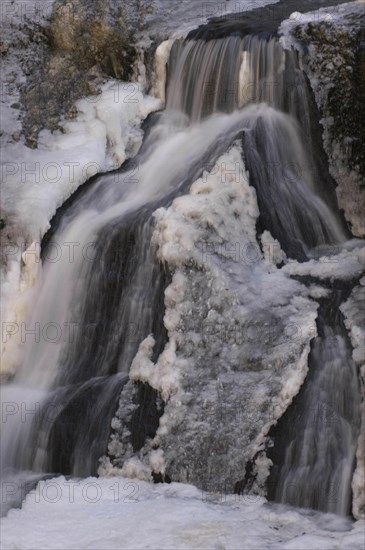 JAPAN, Ibaragi, Fukuroda-no-taki, Fukuroda Waterfalls in the winter with the gushing water at the base of the falls partially frozen into ice