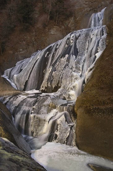 JAPAN, Ibaragi, Fukuroda-no-taki, Fukuroda Waterfalls in the winter with the gushing water at the base of the falls partially frozen into ice