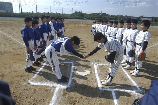 JAPAN, Chiba, Tako, "Toshiki Hagiwara, a 12 year old 6th grader, captain of Toujou Shonen Yakyu Club, shakes hand of Asahi Eagles captain before starting baseball game"