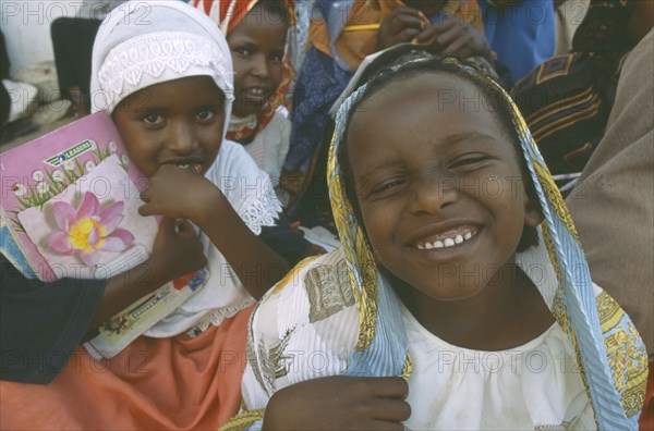 SOMALILAND, Hargeisa, Laughing girl in crowd.