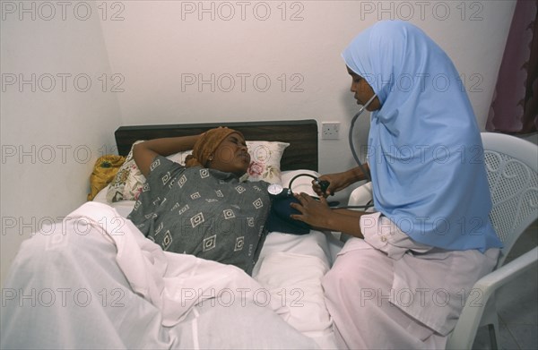 SOMALILAND, Hargeisa, Nurse taking blood pressure of pregnant woman in Edna Adan maternity hospital.