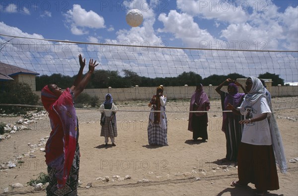 SOMALILAND, Hargeisa, Girls playing volleyball at Fatima Bihi school wearing long skirts and head coverings.