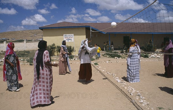 SOMALILAND, Hargeisa, Girls playing volleyball at Fatima Bihi school wearing long skirts and head coverings.