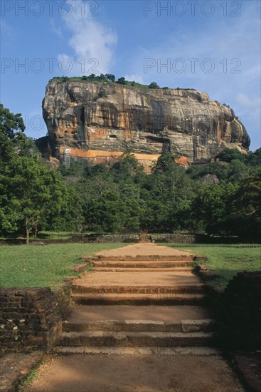 SRI LANKA, Sigiriya, View along path toward huge monolithic rock site of fifth century citadel. Also called Lion Rock.