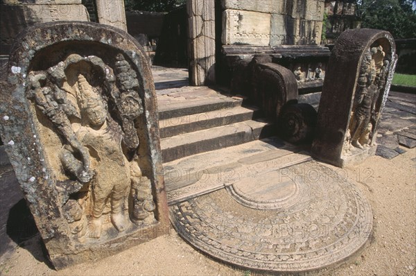 SRI LANKA, Polonnaruwa, The Hatadage circular relic house. Detail of a guardstone which flanks one of the four entrances of the inner terrace and moonstone leading to the central dagoba