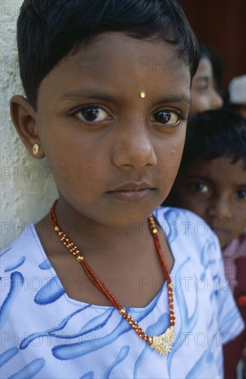 SRI LANKA, Dambetenne, Portrait of a young schoolgirl wearing gold jewellery