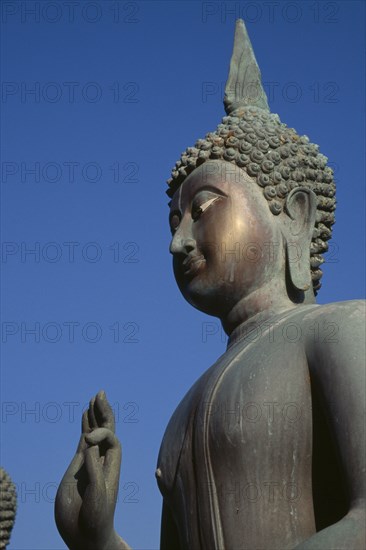 SRI LANKA, Colombo, Seema Malakaya on Beira Lake. Angled view looking up at the head and hand of a Buddha statue