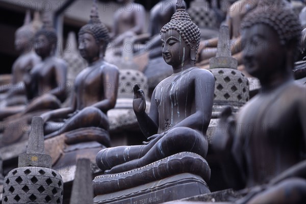 SRI LANKA, Colombo, Gangaramaya Temple. Mass of seated Buddha statues