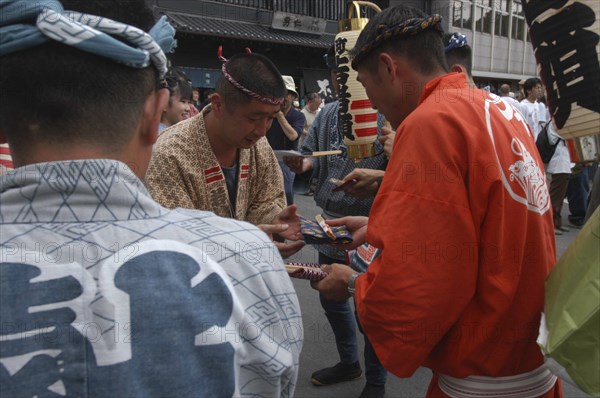 JAPAN, Chiba, Narita, "Gion Matsuri. Men in Edo-era costume, each specific to their neighborhood, exchange gifts before starting that days activities"