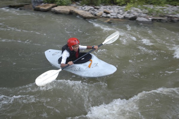 USA, New York, Rochester, "12 year old Japanese student Satoshi Ui, rides white water during a kayaking class of Genessee Waterways Center at Lock 32"