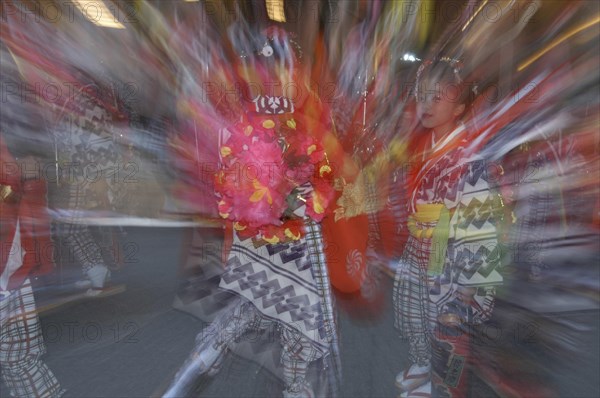 JAPAN, Chiba, Narita , "8-12 year old girls called ""tekomae"" in traditional Edo-era costumes, wait to proceed their neighborhood Dashi or wagon, pulled through the streets during Gion matsuri. Radial blur."