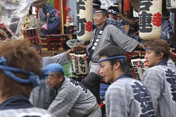 JAPAN, Chiba, Narita, Men in traditional Edo-era costumes wait to pull their neighborhood dashi or wagon during Gion Matsuri