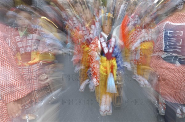 JAPAN, Chiba, Narita, "Maki Tsuchiya, 9 years old, leads the ""tekomae"", young girls proceeding the wagon pulled during Gion Matsuri wearing traditional Edo-era costume Radial Blur."