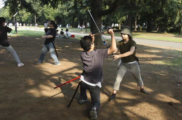 JAPAN, Honshu, Tokyo, "Harajuku. Yoyogi Park on Saturday afternoon, Miyuki Wada aged 31 and Takaki Hagi aged 20, practice sword fighting for Ichigaya Tanabata Festival"
