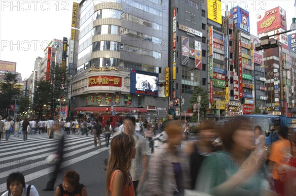 JAPAN, Honshu, Tokyo, Shinjuku. Entertainment district Kabukicho on Saturday evening with pedestrian crossing of Yasukuni-dori in the foreground