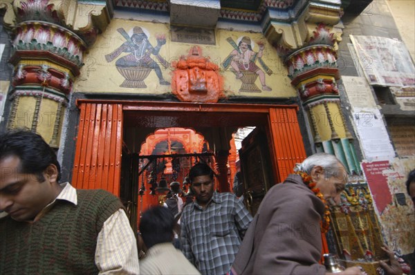 INDIA, Uttar Pradesh, Varanasi , Worshippers enter and leave Kala Bhairava Temple