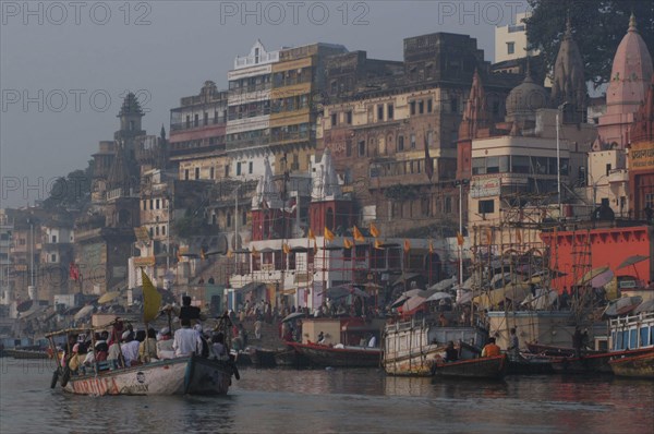 INDIA, Uttar Pradesh, Varanasi , Dashaswamedh Ghat on the Ganges River looking south with boats and bathers