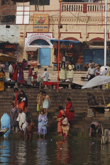 INDIA, Uttar Pradesh, Sarnath, Dashaswamedh Ghat with early morning bathers in the Ganges River