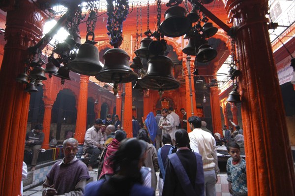INDIA, Uttar Pradesh, Varanasi , Kala Bhairava Temple. Temple interior with bells and worshippers