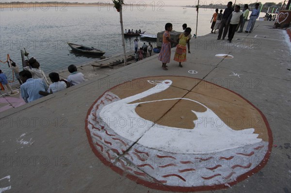 INDIA, Uttar Pradesh, Varanasi , Deep Diwali Festival. Symbol of Goddess Saraswati painted on the pavement of a ghat by the Ganges River