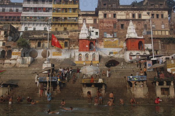 INDIA, Uttar Pradesh, Varanasi , Dashaswamedh Ghat with early morning bathers in the Ganges River