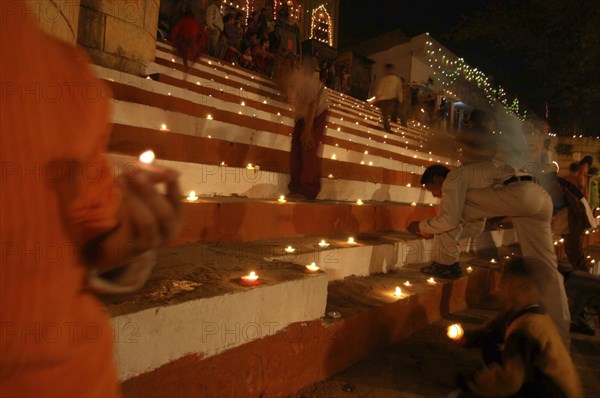 INDIA, Uttar Pradesh, Varanasi, Deep Diwali Festival with oil lamps on steps leading down to the Ganges River