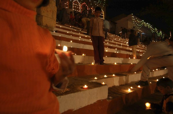 INDIA, Uttar Pradesh, Varanasi, Deep Diwali festival with oil lamps on the steps leading down to the Ganges River