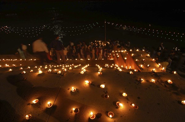 INDIA, Uttar Pradesh, Varanasi, Deep Diwali Festival. Oil lamps on the steps leading down to the Ganges River