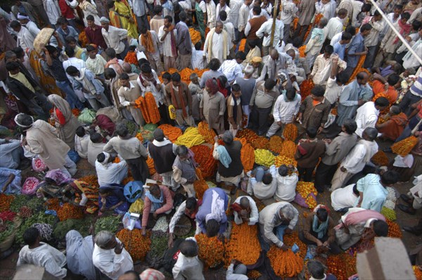 INDIA, Uttar Pradesh, Varanasi, View looking down on busy flower market with a majority of male vendors selling mostly marigolds