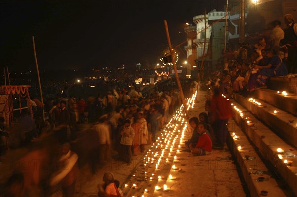 INDIA, Uttar Pradesh, Varanasi, Deep Devali Festival on the ghats lining the Ganges River with festival goers lighting oil lamps